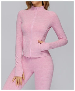 Detail of pink brushed gym jacket featuring thumbhole cuffs and secure zipper pockets