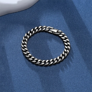 Retro punk cuban link chain bracelet in silver grey metal finish on dark blue background
