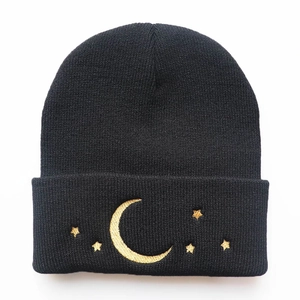 Black knit beanie featuring golden moon and star embroidery for autumn and winter warmth