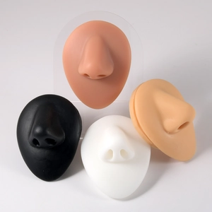 Detailed view of silicone nose models in four skin tones for piercing practice