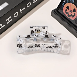 Detail of Halloween hair claw clip with ghost and skeleton prints on transparent acrylic