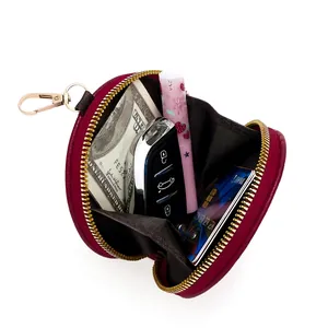 Deep red circular leather coin purse with gold zipper and metal hook for keys and cards