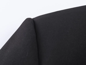 Detailed macro view of black woven fabric texture on a ruffle waist commuter jacket