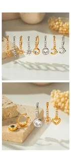Detailed view of gold and silver copper earrings with zircon inlaid geometric charms