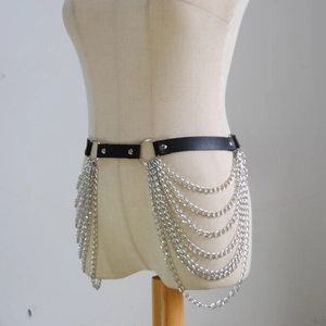 Detail of black PU leather waist belt with layered silver metal chains and studs
