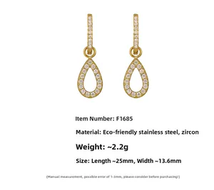 Detailed view of teardrop stainless steel earrings with gold plating and cubic zirconia