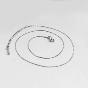 Detailed macro view of silver stainless steel chain necklace with lobster clasp
