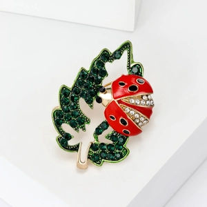Chic gold-plated ladybug brooch on green crystal leaf with sparkling rhinestones