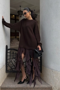 Detailed view of dark brown oversized knit sweater with layered ruffle chiffon skirt texture