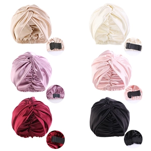 Detail view of adjustable satin sleep caps in six colors showing the silk texture and straps