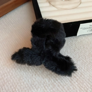 Close-up of black plush cloud-shaped hair claw clip with soft faux fur texture