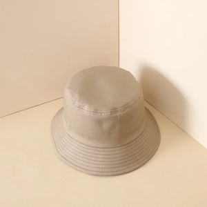 Detail of khaki twill cotton bucket hat with premium stitching in a minimalist studio setting