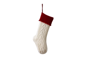 Detail of red and white knitted Christmas stocking with cable pattern and hanging loop