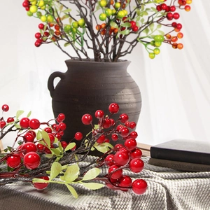 Artificial red berry branches in a ceramic vase for elegant home interior decoration
