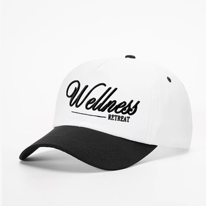 Detail view of cotton baseball cap with Wellness RETREAT embroidery and contrast brim
