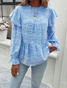 Detailed view of women's blue floral blouse featuring ruffle shoulders and elegant long sleeves