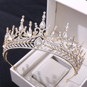 Detailed close-up of a luxury gold bridal crown with crystals on a white display box