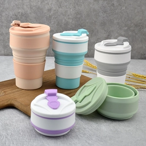 Portable collapsible silicone travel cups in five colors shown both expanded and folded