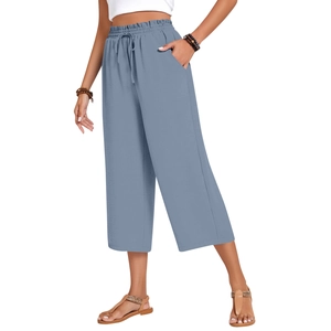 Detail of high waisted linen pants featuring elastic drawstring waist and side pockets