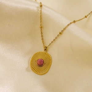 14K gold plated stainless steel sunburst necklace with pink stone on satin