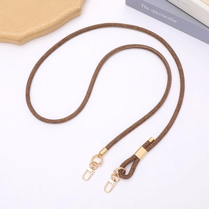 Detail of a brown braided phone lanyard with gold metal lobster clasps and slider