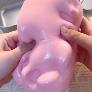 Pink slow rising squishy food toy showing high elasticity and soft clay texture for stress relief