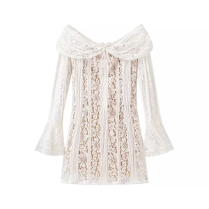 Detail of elegant white lace mini dress showing refined textures and off-shoulder design