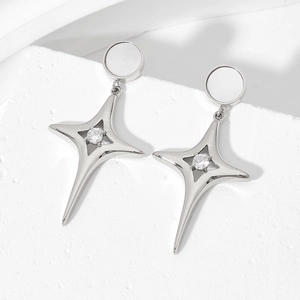 Minimalist silver stainless steel star earrings with sparkling zircon on stone background