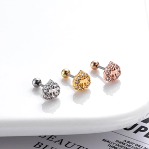 Macro detail of three elephant ear studs in silver, gold, and rose gold with tiny zircons