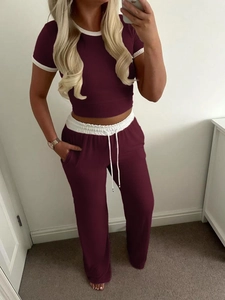 Detailed texture of burgundy ribbed knit short sleeve top and matching high waist pants