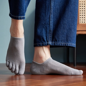 Detail of grey men's five-toe socks featuring breathable mesh texture and low-cut design