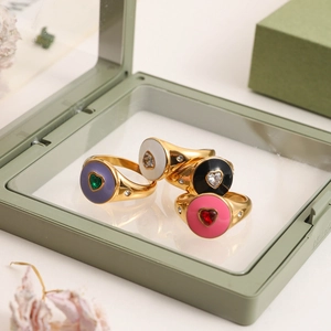 Detail of colorful heart rings in gold finish with zircon accents on display