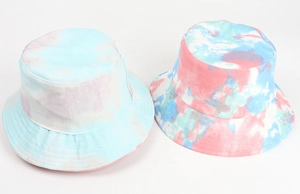 Detailed close-up of colorful tie-dye bucket hats in blue, purple, and red cotton twill