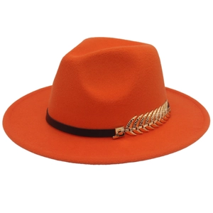 Detail of orange fedora wool hat featuring a golden wheat ear metal buckle accessory