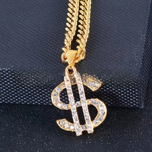 Hip hop gold necklace with a dollar sign pendant and Cuban link on a black box