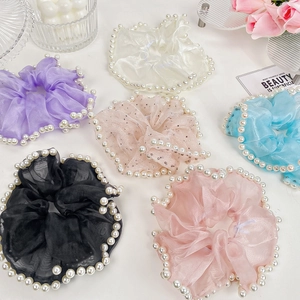 Six-piece set of mesh pearl scrunchies in assorted pastel colors for hair styling