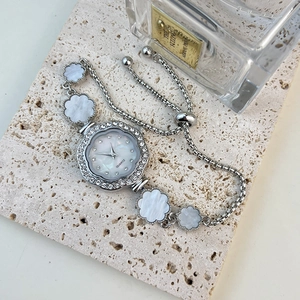 Detail of silver floral quartz watch with mother of pearl dial and adjustable clasp