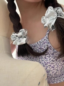 Detailed view of large silver metallic scrunchie showing faux leather texture and shine