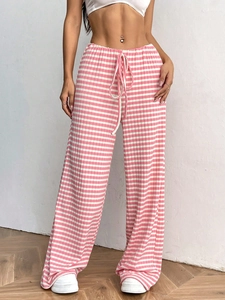 Detail of pink and white striped knit pants with elastic drawstring waist and vertical texture