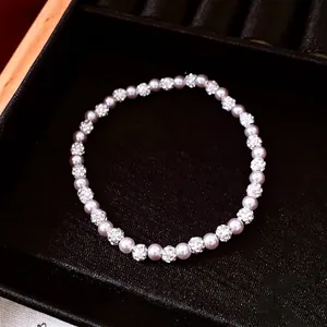 Elegant beaded pearl bracelet with zircon pavé accents on a black jewelry display box