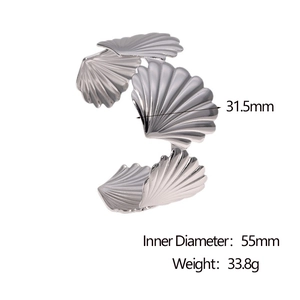 Detailed view of wide scallop shell cuff bracelet in silver stainless steel finish
