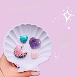 Natural heart crystal stones including Amethyst and Rose Quartz in a shell dish