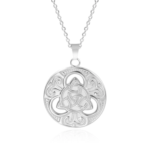Macro shot of a silver circular hollow pendant with an intricate Celtic knot on white surface