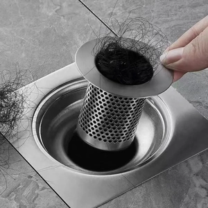 Detail of stainless steel drain filter basket capturing hair to prevent clogging