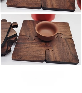Detailed view of puzzle-shaped walnut wood coaster with natural grain and interlocking edges