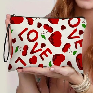 Portable canvas makeup bag with red hearts cherry prints and LOVE text on white surface