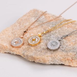Star engraved shell round necklace in rose gold, gold and silver on textured stone