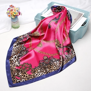 Detail of rose red leopard print satin silk square scarf with luxury chain pattern edge