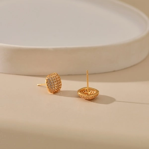 Macro view of gold plated square cushion stud earrings with pavé set cubic zirconia