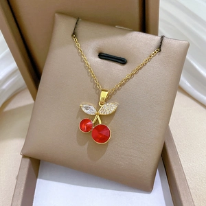 Elegant gold titanium steel necklace with red cherry pendant and sparkling crystals